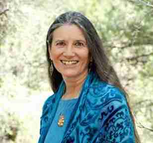 Woman with long brown hair and blue top